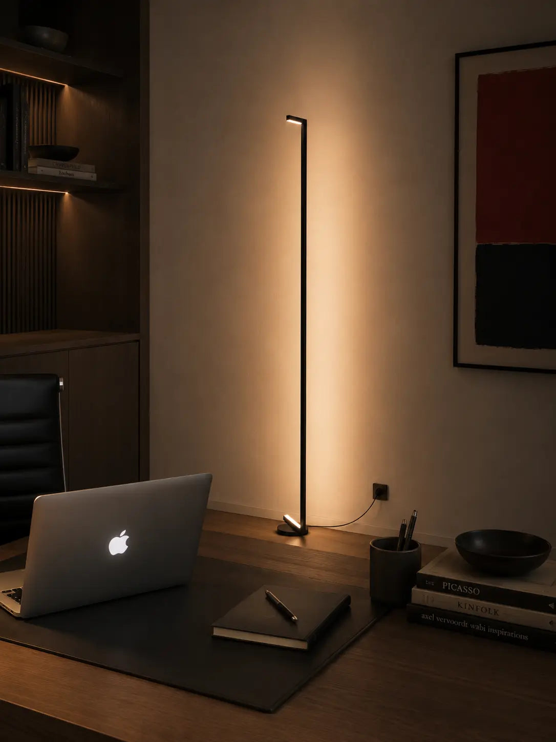 Tratto Floor Lamp in a refined interior, casting warm indirect light against the wall and creating a calm sculptural atmosphere with soft shadows.