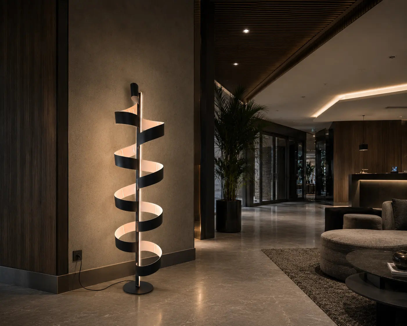 Aura floor lamp casting warm indirect light on the wall, creating depth and a soft sculptural atmosphere in a contemporary interior