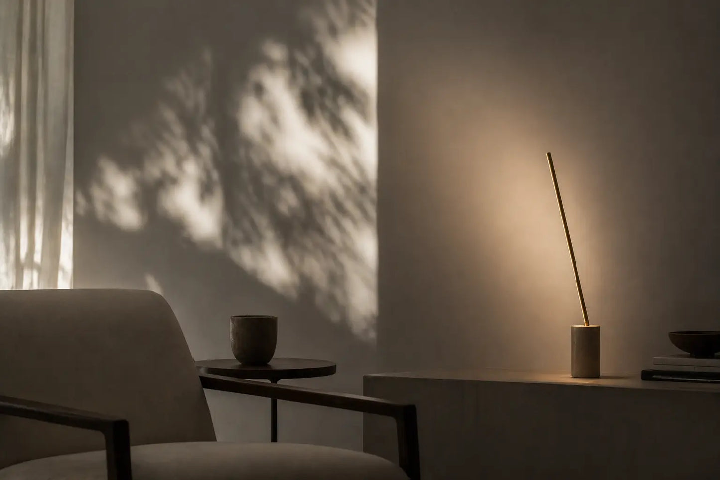 Handcrafted sculptural floor lamp casting soft indirect light on a wall in a calm minimalist interior