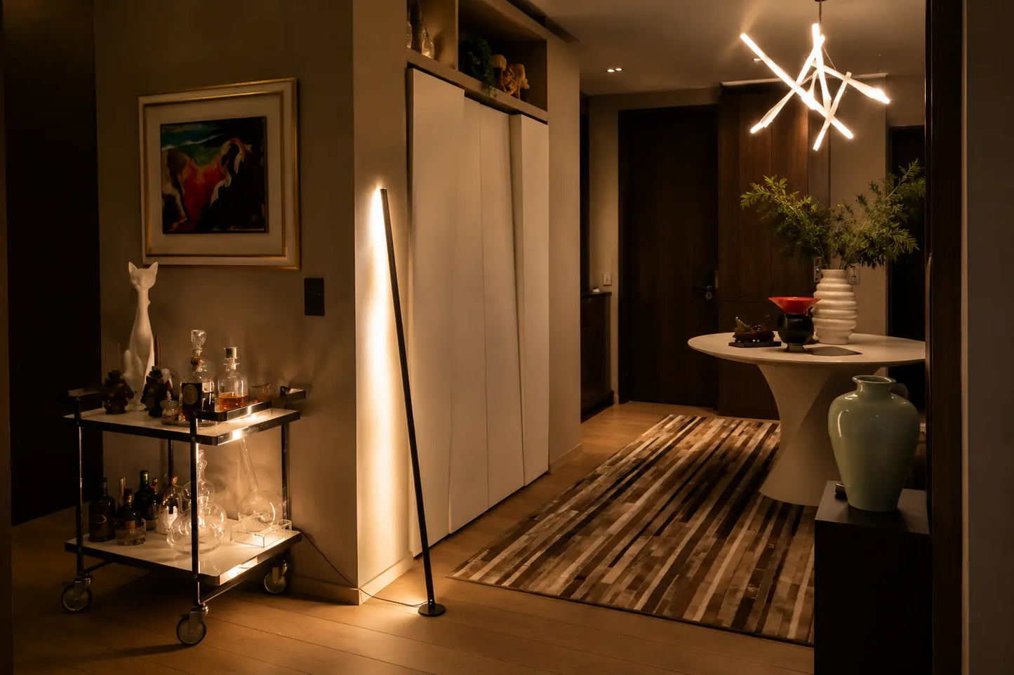 Gica Contra sculptural floor lamp by Tommaso Cristofaro, handmade minimalist indirect light lamp with warm wall reflection in a refined modern interior.
