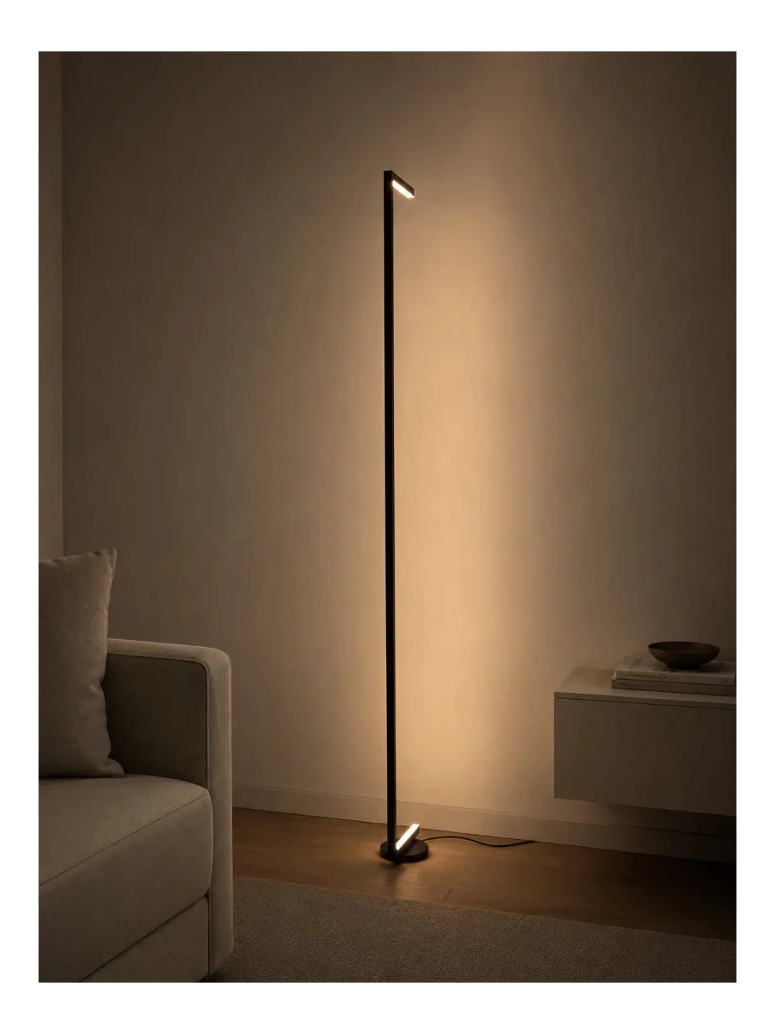 Tratto Floor Lamp by Tommaso Cristofaro in a modern minimalist interior, casting warm indirect light against the wall with a slim sculptural presence.