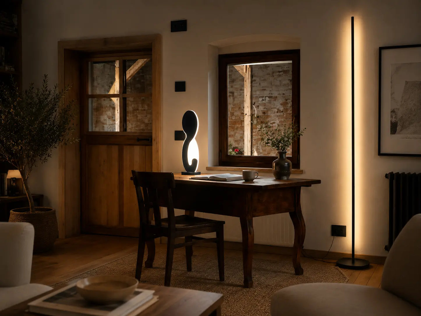 Yellow sculptural table lamp by Tommaso Cristofaro on a wooden sideboard in a minimalist living room, creating warm ambient light with elegant modern decor.