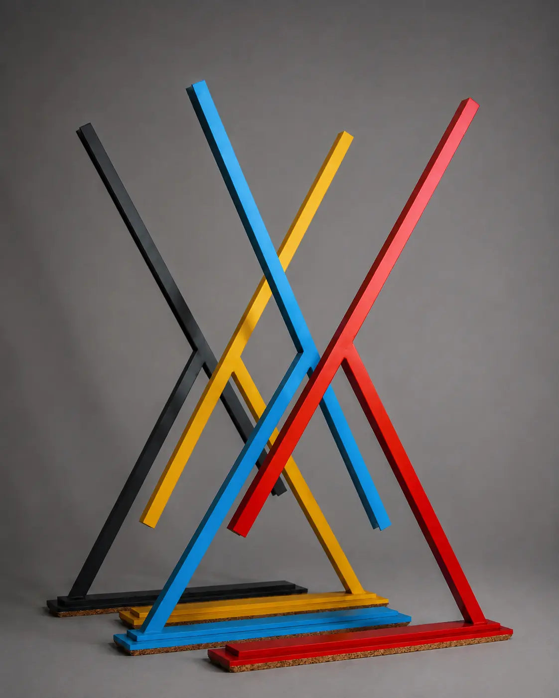 Colorful handmade Achille table lamps by Tommaso Cristofaro, minimalist sculptural lighting in red, blue, yellow and dark grey with natural cork base.