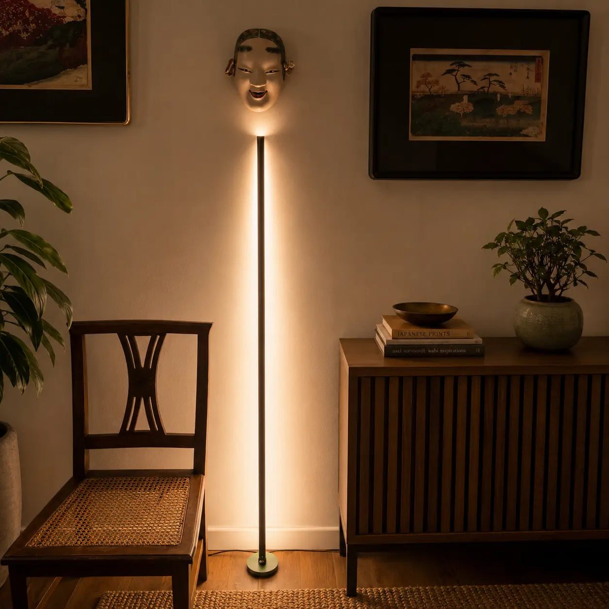 Gica Contra Floor Lamp 150 casting warm indirect light against the wall in a minimalist interior.