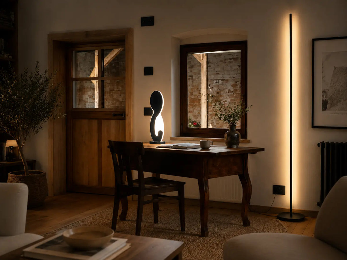 Gica Contra 195 sculptural floor lamp casting warm indirect light in a dining room interior.